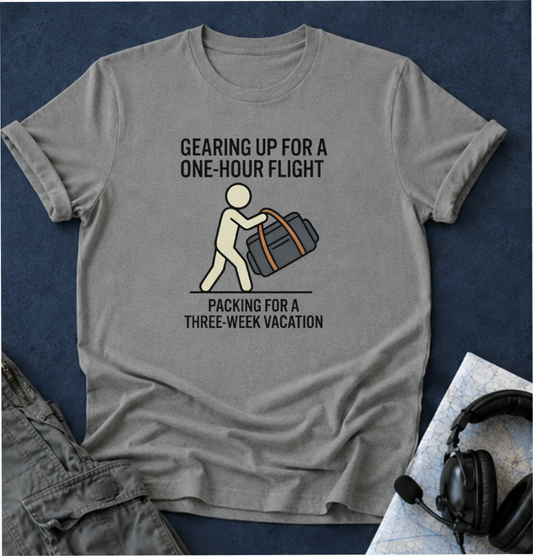 Packing Humor T-Shirt — "Gearing Up for a One-Hour Flight, Packing for a Three-Week Vacation"